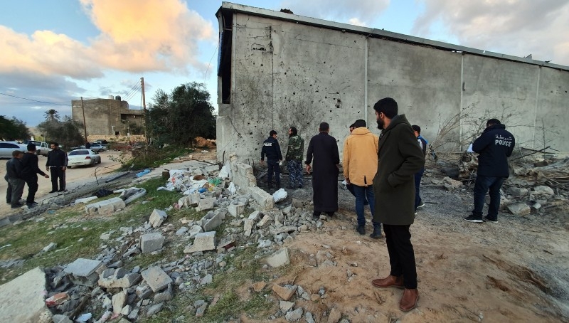 Libyan security members and locals inspect damages on the site of a reported air strike in the capital Tripoli's suburb of Tajoura in this Dec. 29, 2019 file photo. — AFP