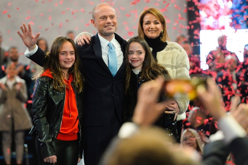 Malta's outgoing Prime Minister and outgoing Labour party leader, Joseph Muscat (C), his wife Michelle (Rear R) and their daughters Etoile Ella Muscat (Front R) and Soleil Sophie Muscat unite on stage following Muscat's final speech as PM on Friday in Paola, Malta, before standing down over a slain reporter scandal. -AFP