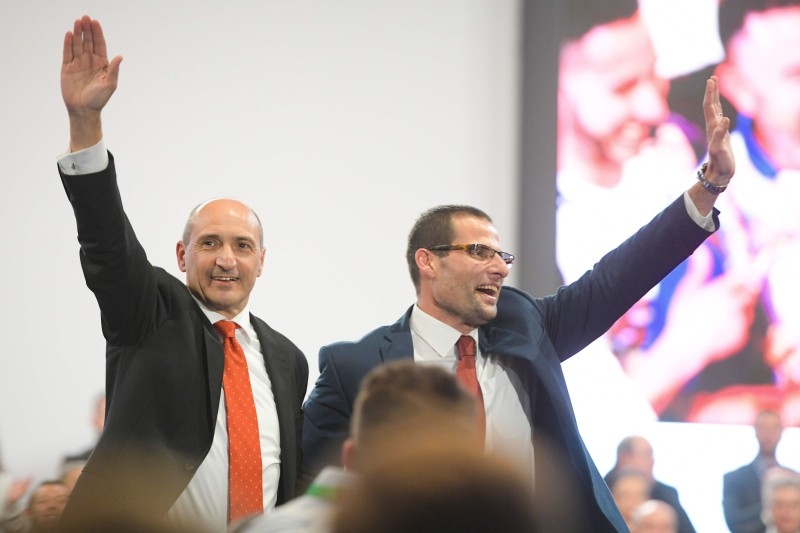 Malta's outgoing Prime Minister and outgoing Labour party leader, Joseph Muscat (C), his wife Michelle (Rear R) and their daughters Etoile Ella Muscat (Front R) and Soleil Sophie Muscat unite on stage following Muscat's final speech as PM on Friday in Paola, Malta, before standing down over a slain reporter scandal. -AFP