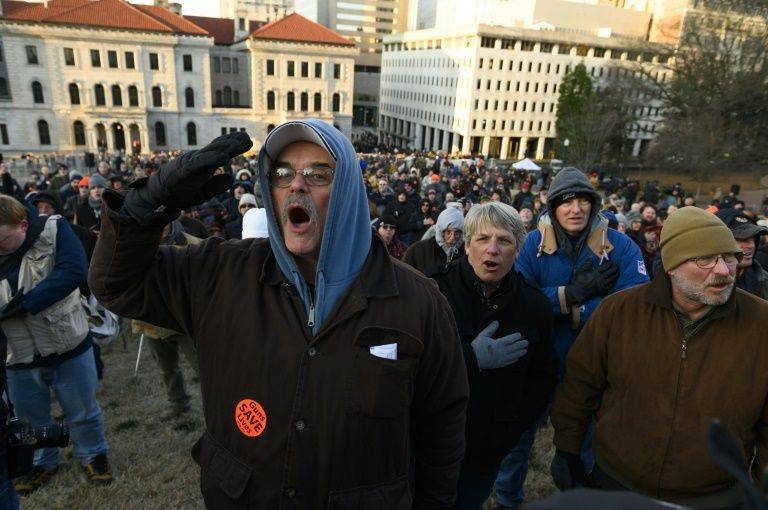 Hundreds more gathered in the streets surrounding the Capitol building, a few bearing arms, which is permitted outside the designated rally area. — AFP