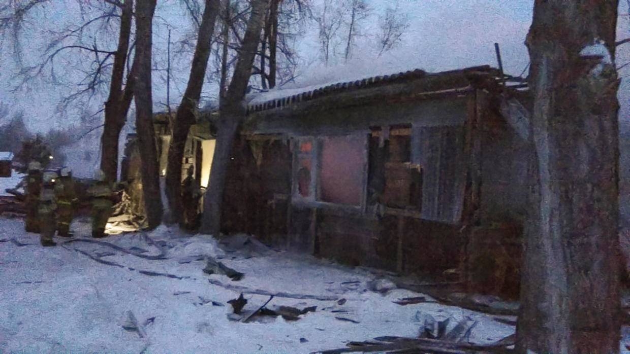 This handout picture released by the Russian Emergencies Ministry shows firefighters working at the site of a fire that broke out in a one-storey wooden shack in the Prichulymsky settlement in Russia's Tomsk region on Tuesday. — AFP