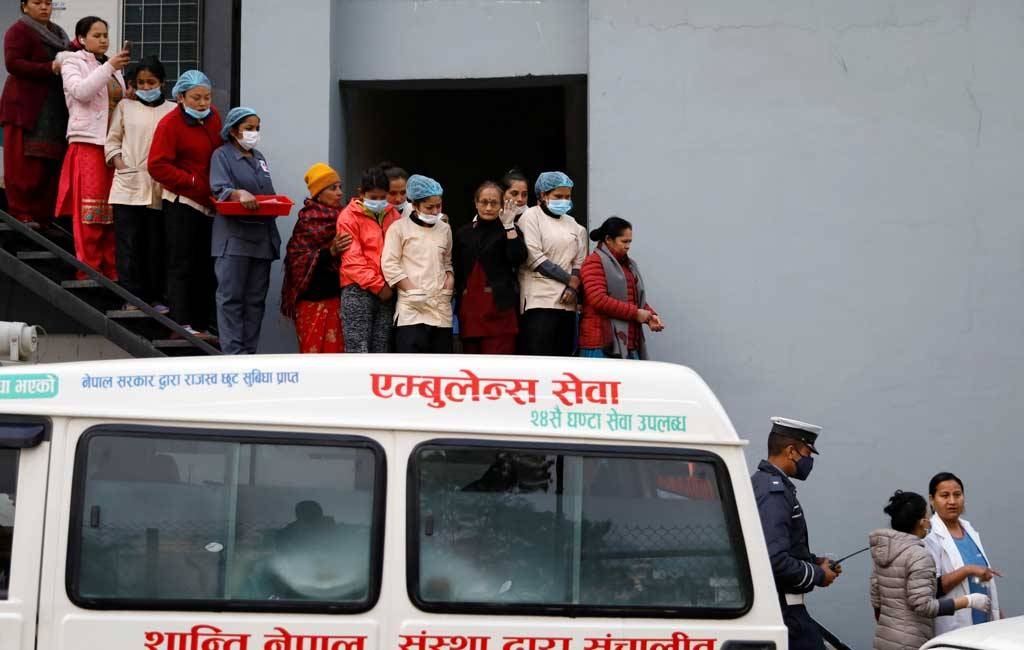 Hospital staff observe as the bodies of eight Indian tourists who died due to suspected suffocation are carried inside an ambulance while being taken for postmortem in Kathmandu, Nepal, on Wednesday. — Courtesy photo