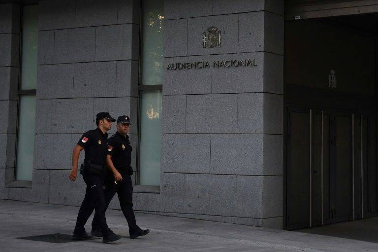 Spanish policemen walk in front of the National Court in Madrid. — AFP
