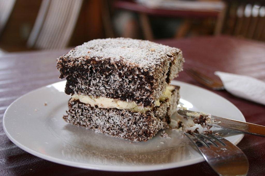 Lamingtons, a traditional Australian dessert, are cube-shaped sponge cakes dipped in chocolate and covered in grated coconut. — Courtesy photo