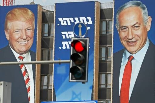 An Israeli election banner bears the portraits of US President Donald Trump, left, and Prime Minister Benjamin Netanyahu hanging on a building facade in Jerusalem in this September 14, 2019 file photo. — AFP