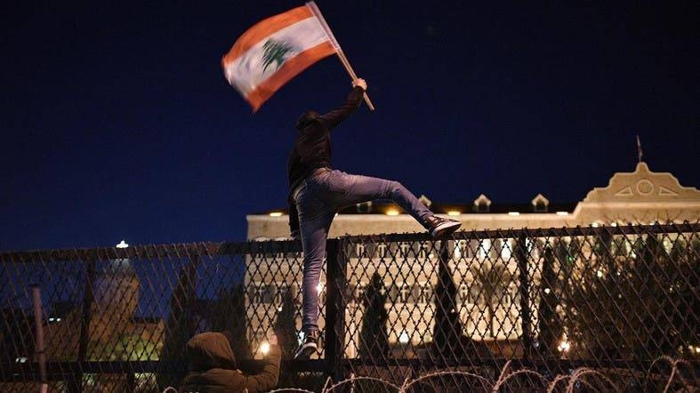 Protesters attack barriers in front of the Grand Serail, the prime minister's headquarters, in Beirut. — Courtesy photo