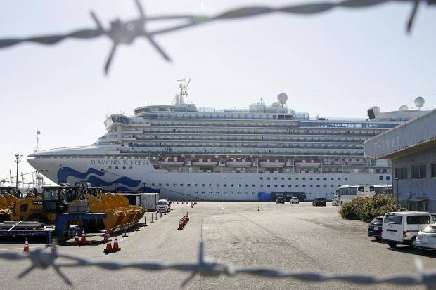 The quarantined ship Diamond Princess is pictured through barbed wire at Yokohama port in Yokohama, near Tokyo on Monday. — Courtesy photo