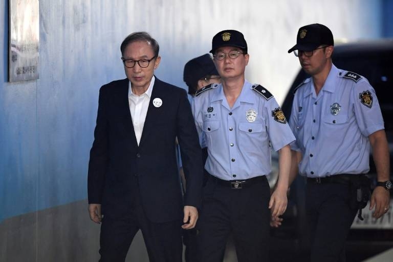 Former South Korean president Lee Myung-bak arrives at court to attend his original trial in 2018. — AFP