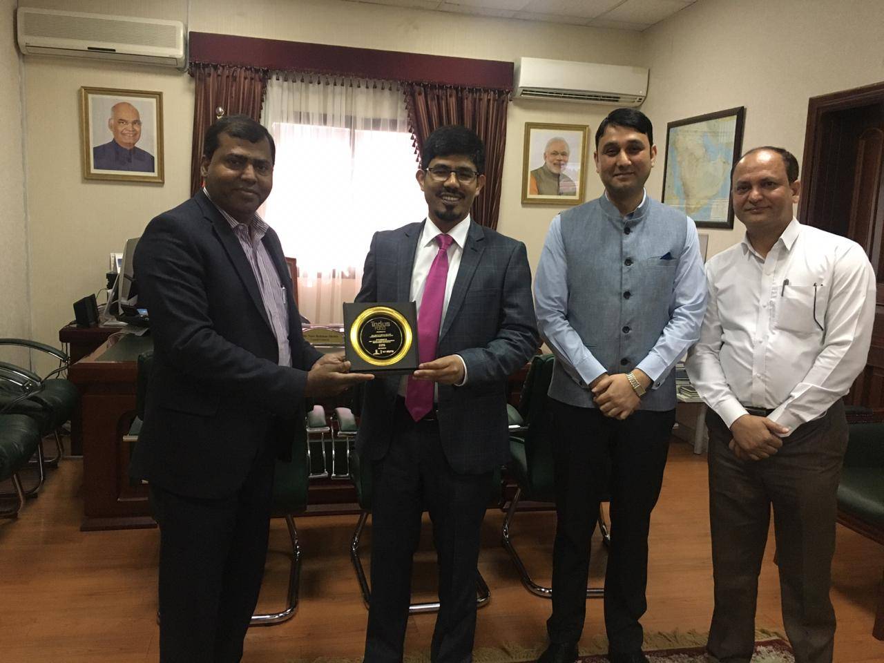 Indian Consul General Md. Noor Rahman Sheikh, center, along with Consul (consular) Sahil Sharma and Amjad Shareef, marketing research assistant, presents an award to SIBN General Secretary Mir Gazanfar Ali Zaki, left.