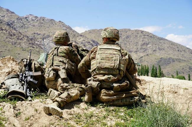 US soldiers look out over hillsides during a visit of the commander of US and NATO forces in Afghanistan in 2019. — AFP