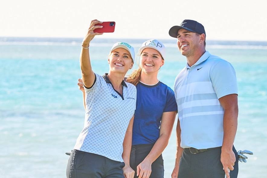 Amy Boulden and Rachel Drummond pose with Brooks Koepka. — Courtesy photos