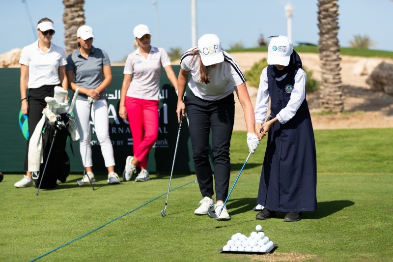 Amy Boulden and Rachel Drummond pose with Brooks Koepka. — Courtesy photos