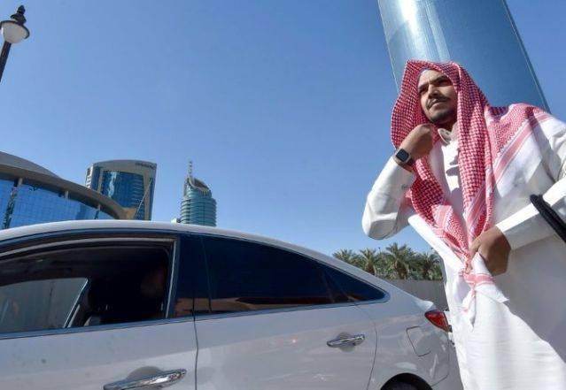 Hussein starts his day's work for ride-hailing service Uber in the Saudi capital Riyadh. 