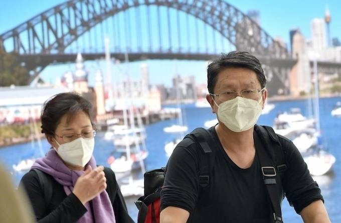 Australia's prime minister said the country considered the new coronavirus to be a pandemic Thursday, going a step beyond the WHO as he extended a travel ban on visitors from China. — AFP