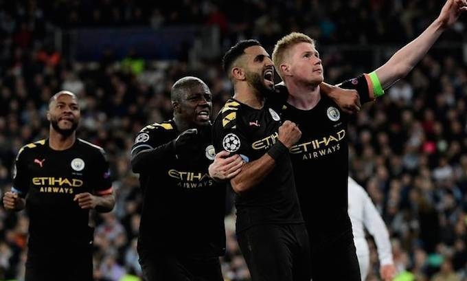 Kevin De Bruyne celebrates his goal with teammates as he orchestrates a dramatic Manchester City comeback on Wednesday as they stunned Real Madrid 2-1 at the Santiago Bernabeu to put one foot in the Champions League quarterfinals. — AFP