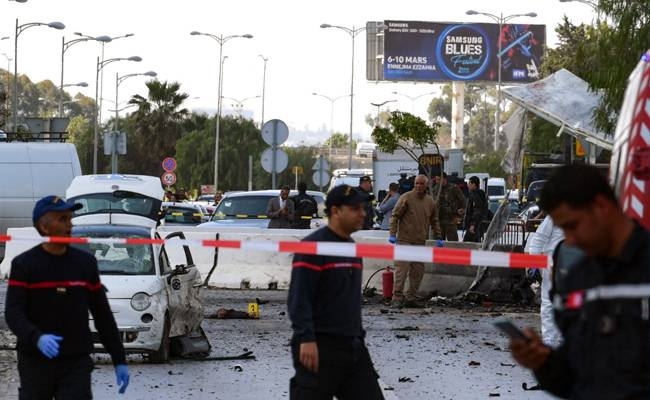 Police and firefighters gather at the scene of an explosion near the US embassy in the Tunisian capital Tunis on Friday. A blast that rocked Tunis today was an attack that targeted the US embassy and caused injuries among policemen, police said. — AFP