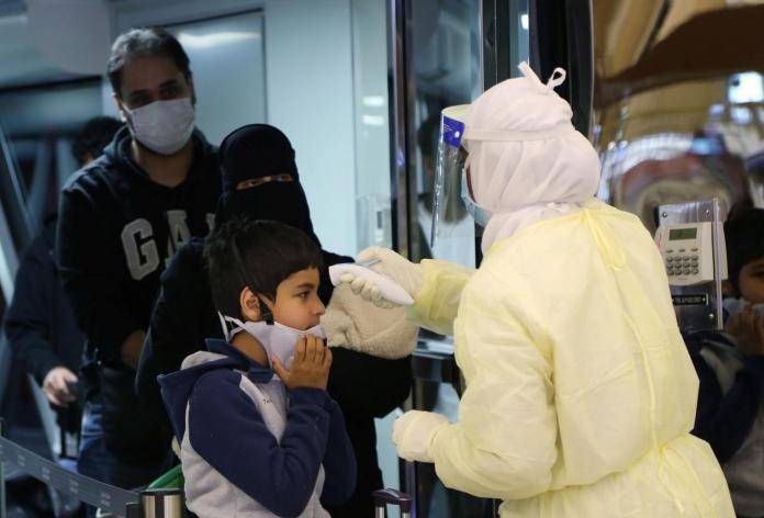 Passengers coming from china are checked by Saudi health ministry employees upon their arrival at King Khalid international airport in Riyadh.