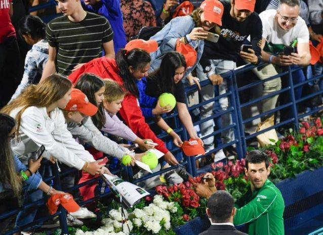 Serbia's Novak Djokovic signs autographs after winning ATP final in Dubai in this file photo. The ATP and WTA tours have instructed players not to accept items to sign as part of measures to combat the spread of COVID-19. — AFP