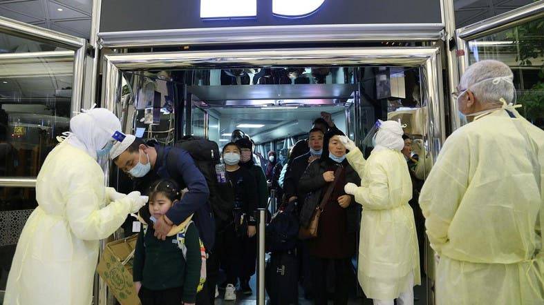 Passengers coming from China wearing masks to prevent a new coronavirus are checked by Saudi Health Ministry employees upon their arrival at King Khalid International Airport, in Riyadh. — Courtesy photo