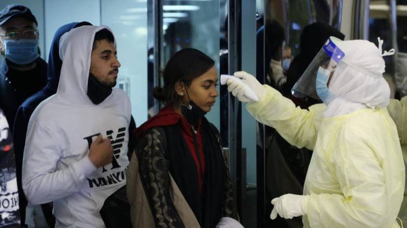 Passengers wearing masks to prevent a new coronavirus are checked by Saudi Arabia's Health Ministry employees upon their arrival at King Khalid International Airport, in Riyadh. — File Photo