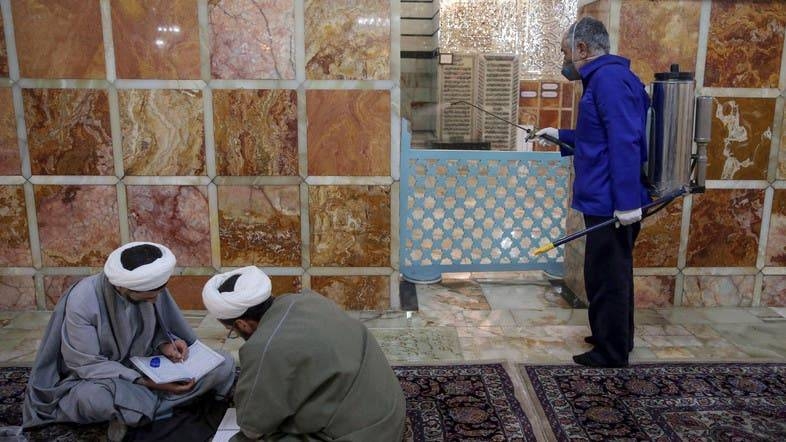 A sanitary worker disinfects a shrine in Qom, Iran. — Courtesy photos
