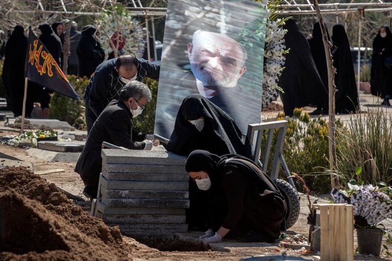 A sanitary worker disinfects a shrine in Qom, Iran. — Courtesy photos
