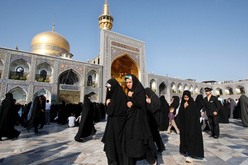 A sanitary worker disinfects a shrine in Qom, Iran. — Courtesy photos
