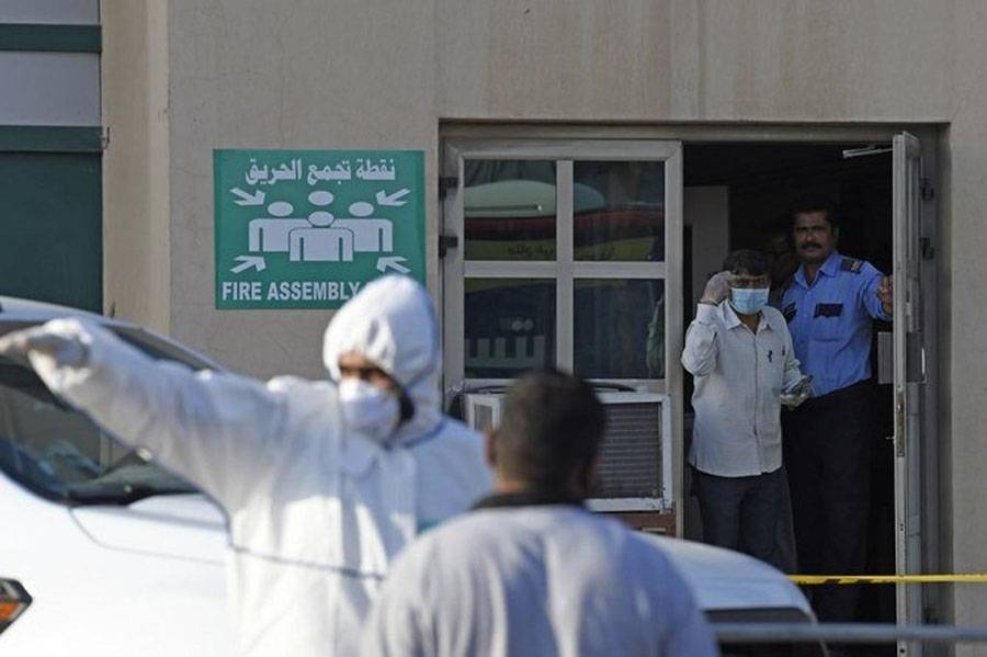 Bahraini security officials seal off a residential flat housing foreign workers in Salmabad industrial area in this March 13, 2020 file photo. — Courtesy photo