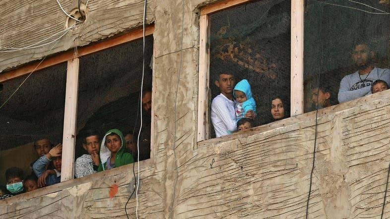 Syrian refugees in a building under construction they have been using as a shelter in the city of Sidon in southern Lebanon.