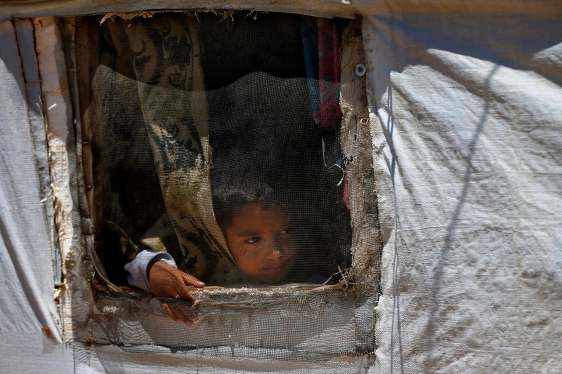 Syrian refugees in a building under construction they have been using as a shelter in the city of Sidon in southern Lebanon.