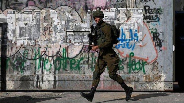 An Israeli soldier runs during an anti-Israel protest by Palestinians in Bethlehem, in the Israeli-occupied West Bank. -- Courtesy photo