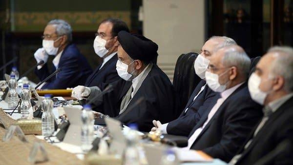 Cabinet members wearing face masks and gloves attend their meeting in Tehran, Iran, Wednesday, in the picture taken on March 18. -- Courtesy photo