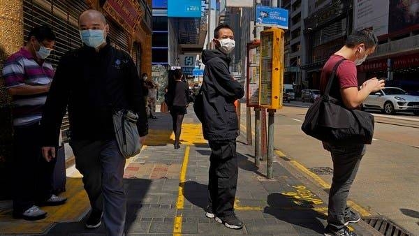 People wearing face masks walk at a downtown street in Hong Kong, Monday -- Courtesy photos


