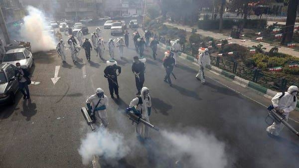 Firefighters disinfect a square against the new coronavirus, in western Tehran in this file photo
