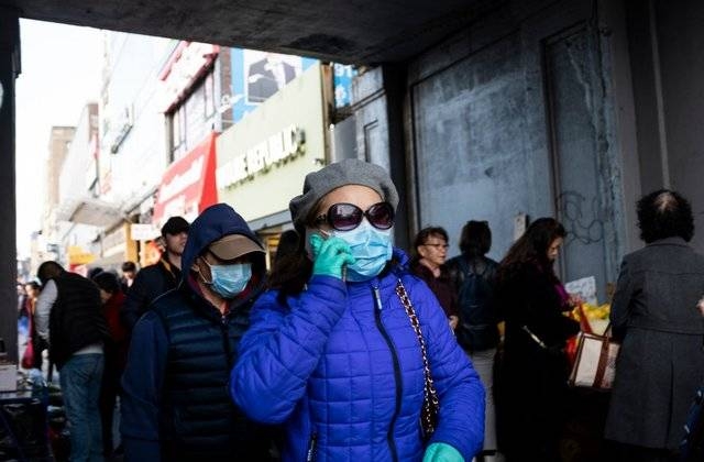 People wear face masks as they walk down a street in New York City in this March 2, 2020 file picture. — Courtesy photo 
