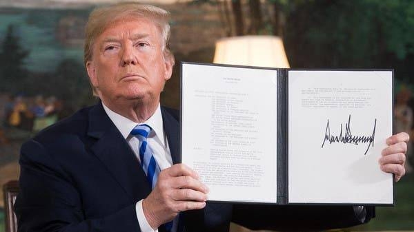 US President Donald Trump is seen signing a document reinstating sanctions against Iran in this May 8, 2018 file photo. — AFP