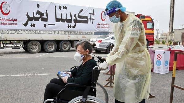 A woman is pushed on a wheelchair as she arrives at a Kuwaiti health ministry containment and screening zone for coronavirus. -- Courtesy photo