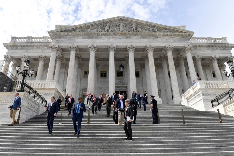 Members of the House of Representatives walk down the steps of Capitol Hill in Washington, on Friday, after passing a coronavirus rescue package. -- Courtesy photo