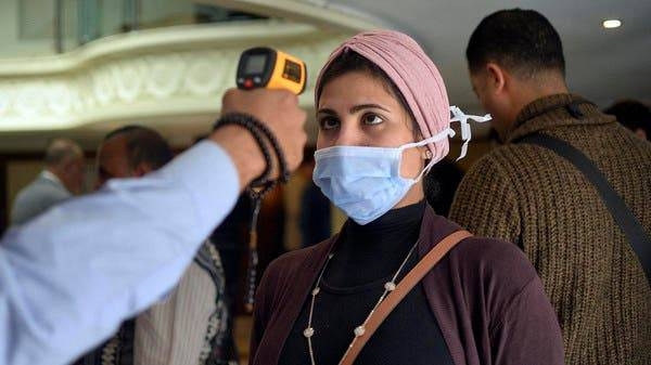 A woman wears a protective health mask has her body temperature is measured on a touristic river boat in Egypt's southern city of Luxor. -- Courtesy photo
