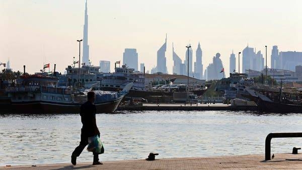 A man walks at Dubai creek where ships are loaded with goods. -- Courtesy photo
