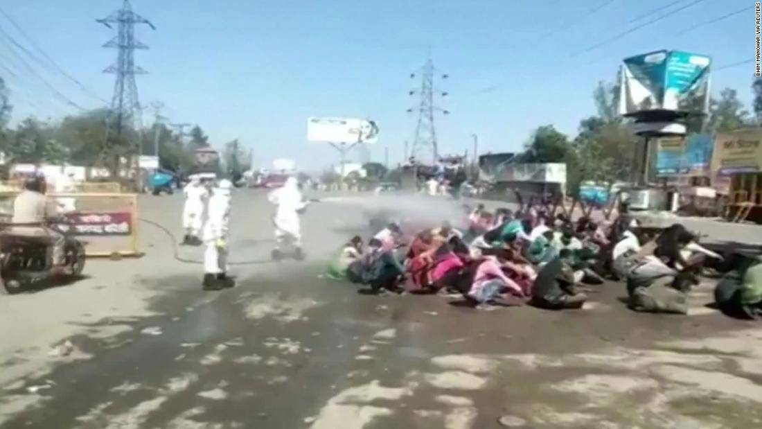 A screengrab of the video shows three people, dressed in protective gear, spraying the liquid directly on a group of workers as they sat on the ground in the city of Bareilly in the northern Indian state of Uttar Pradesh.