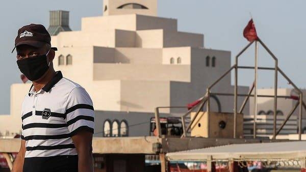 A man wearing a mask walks along the Doha corniche in this file picture. — Courtesy photo