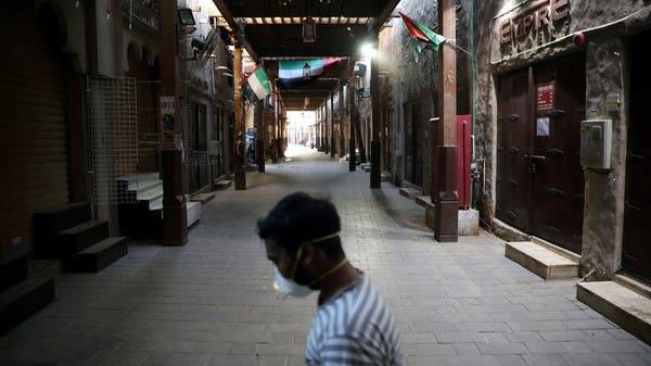 A man wearing a protective face mask walks through the deserted Barajeel Souq in old Dubai. -- File photo
