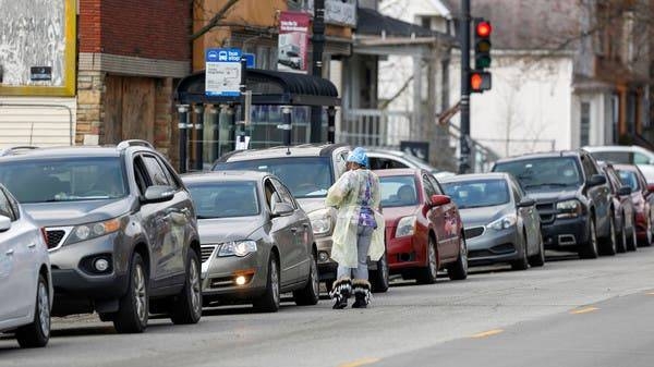 A medical worker speaks to a motorist waiting in line to receive testing during the global outbreak of the coronavirus outside a hospital in Chicago, Illinois. -- Courtesy photo