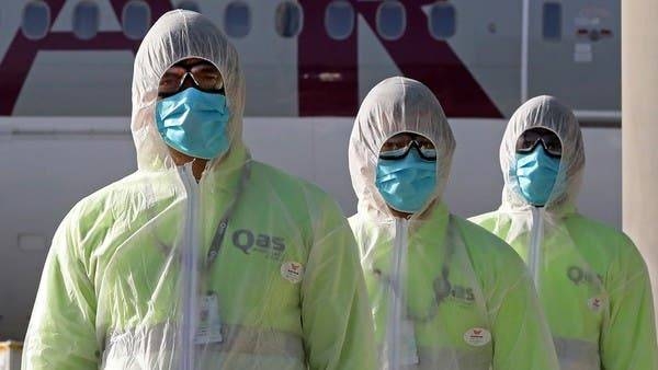 Employees of Qatar Aviation Services (QAS) walk along the tarmac after sanitizing an aircraft at Hamad International Airport in Doha. -- File photo