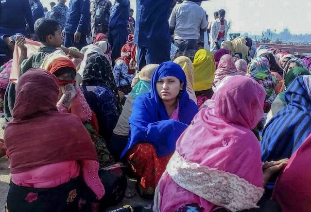 Rohingya refugees wait in an area following a boat capsizing accident in Teknaf, Bangladesh, in this file picture. — Courtesy photo
