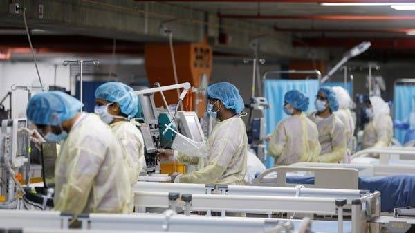 Doctors and nurses are seen doing their final check on the equipment in a makeshift ICU 