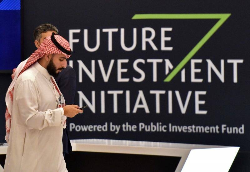 A man walks past a sign at the start of the Future Investment Initiative (FII) in Riyadh, on Oct.23,2019. (AFP)
