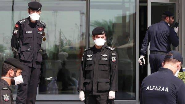 Qatari police stand outside a hotel in Doha where people have been quarantining. -- File photo
