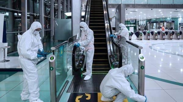 Members of a medical team clean an entry area in Dubai. -- File photo
